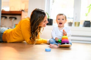 An Adorable Infant Baby Playing At Home Living Room play with her mother